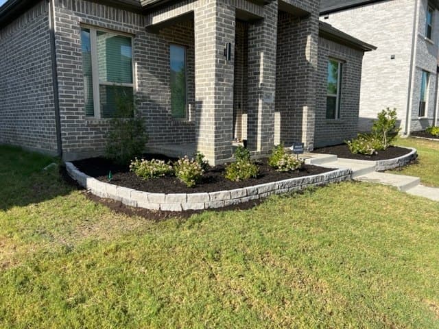 Stone-edged bed with seasonal color